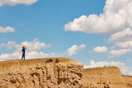 Woman on the top of the mountain with cloudy background. Adventure