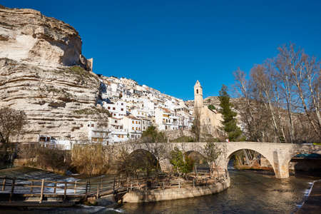 Picturesque white village on the mountain. Alcala del Jucar. Spain