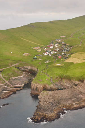 Mykines village and cliffs on Faroe islands from helicopter. Denmarkの写真素材
