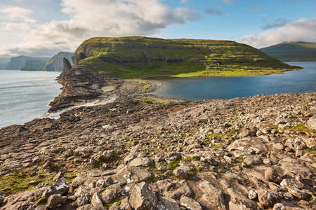 Faroe islands dramatic coastline in Vagar area. Hiking in Faroe archipelago