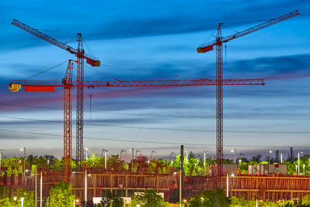 Cranes at sunset. Building under construction. Construction industrial machineryの写真素材