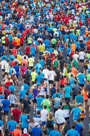 Runners on the street. Athletes in motion. Urban competition. Verticalの写真素材