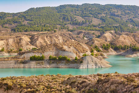 Badlands landscape and blue waters in Algeciras reservoir. Murcia, Spainの写真素材