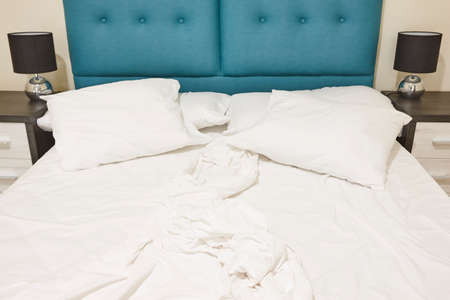 Bedroom with unmade double bed. Indoor nobody. Horizontalの写真素材