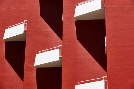 Geometric red building facade. Architectural symmetrical design. Urban perspectiveの写真素材
