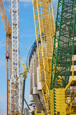Telescopic cranes under a blue sky. Construction engineering industryの写真素材
