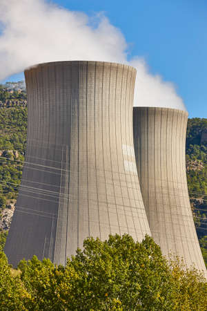 Nuclear power plant chimneys with steam. Sustainable energy