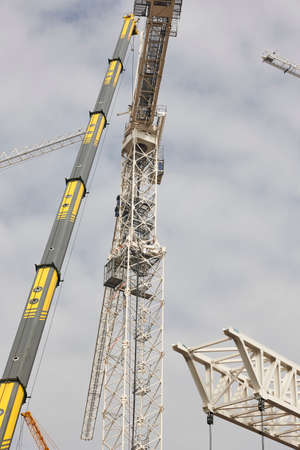 Telescopic cranes under a blue sky. Construction engineering industryの写真素材