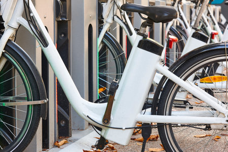 Urban electric bikes charging batteries in the city. For rent