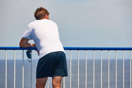 Man gazing out at the sea. Vacation and summer time