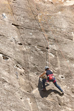 Climber on a granite wall. Extreme sport. Outdoor mountain activity