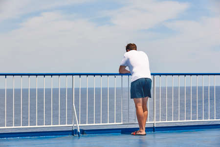 Man gazing out at the sea. Vacation and summer timeの写真素材