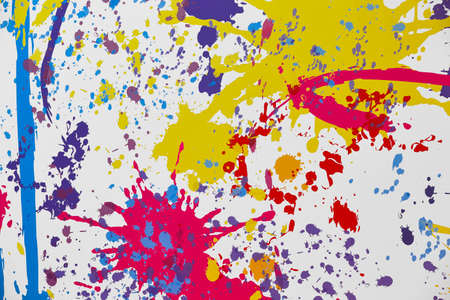 Splashing vibrant painting over a white paper. Multicolor background