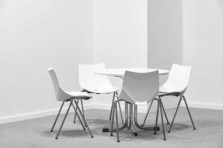 White chairs and table indoor set. Contemporary comfortable plastic furniture