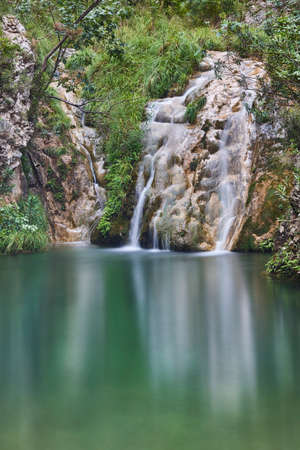 Green pond and waterfall in Valencia, Spain. Chorrador de Otonelの写真素材