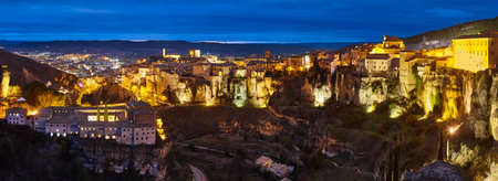 Panoramic illuminated picturesque city of Cuenca at dusk. Spanish highlightの写真素材