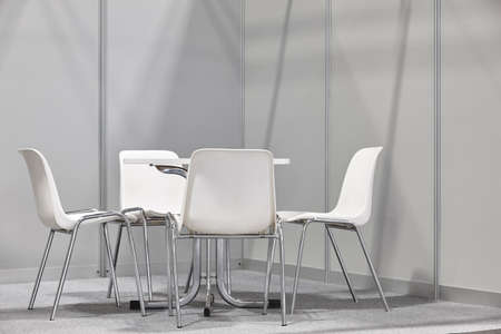White chairs and table indoor set. Contemporary comfortable plastic furnitureの写真素材
