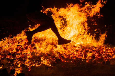 Summer solstice celebration jumping into the fire. Burning flames. Dangerの写真素材