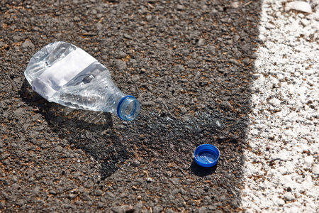 Bottle of water on the asphalt. Waste of water. Environmentalの写真素材