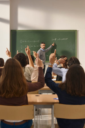 Math teacher giving lessons. Classroom with students. School educationの写真素材