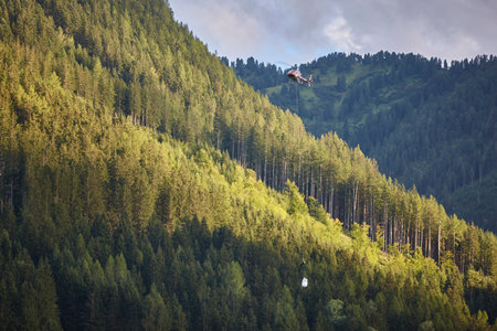 Helicopter rescue training simulation in a mountain range wood. Emergency