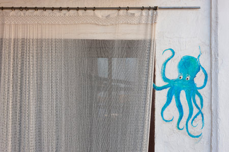 Traditional white mediterranean building facade decorated with an octopusの写真素材