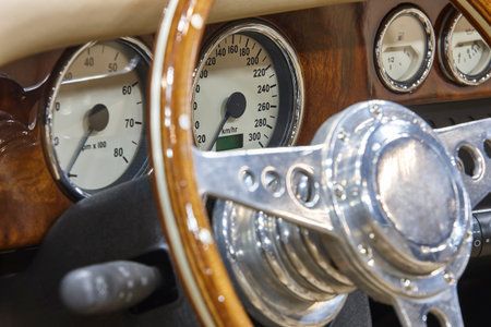 Classic sport car dashboard detail. Motor industry. Analogical instruments