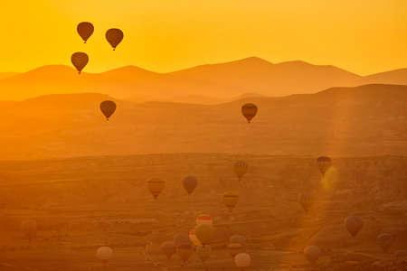 Balloons at dusk in Cappadocia. Spectacular flight in Goreme. Turkeyの写真素材