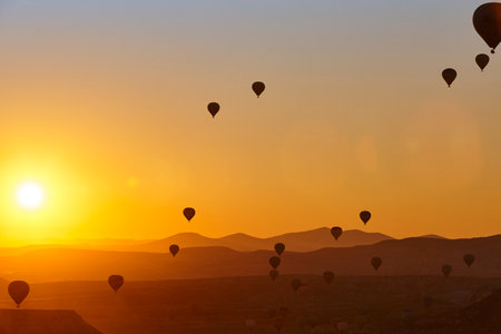 Balloons at dusk in Cappadocia. Spectacular flight in Goreme. Turkeyの写真素材