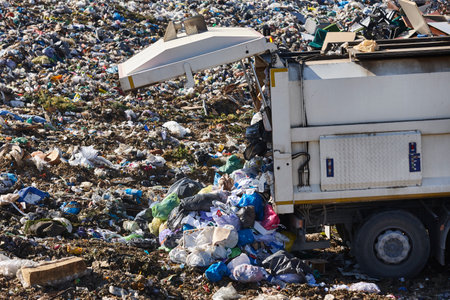 Truck unloading garbage on an open air dump. Waste recyclingの写真素材