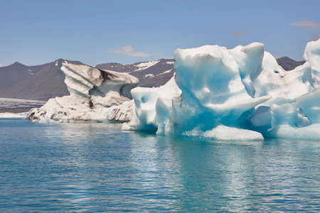 Icebergs, lake and snowy mountains. Jokulsarlon, Southeast area. Iceland.