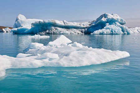 Icebergs, lake and snowy mountains. Jokulsarlon, Southeast area. Iceland