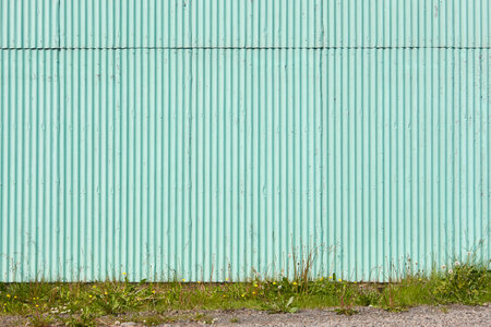 Corrugated facade wall outdoor in green color. Textured backgroundの写真素材