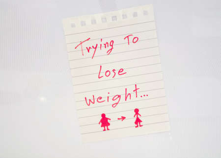 Memo paper on the refrigerator to lose weightの写真素材