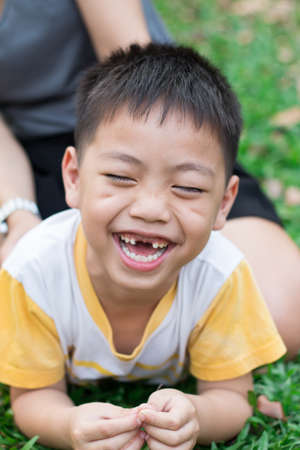 Portrait of a happy little boy in the parkの写真素材