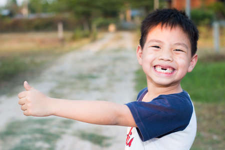 Close up portrait of smiling little boy outdoors