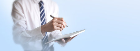 Close up businessman with pen signing contract document making a deal. Focus in hands with pen business concept on bright blur backgroundの写真素材