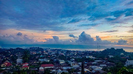 A picture of Manado City, Indonesia, Taken from the Loreng Hill, Tuminting while the sun is setting.の写真素材