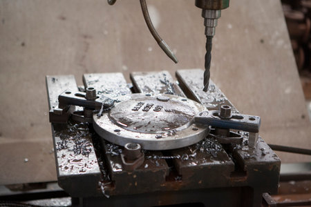 The drilling machine is in the process of drilling the flange which is part of the WCB material...