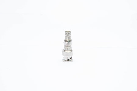 A close-up of a metal connector fitting against a white background, showcasing its intricate design...