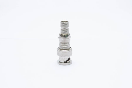 A close-up of a metal connector fitting against a white background, showcasing its intricate design...