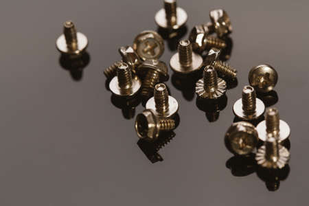 screws for a computer on a dark background.の写真素材