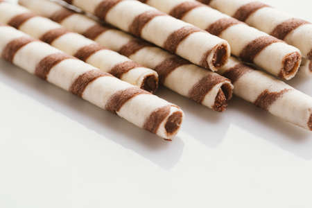 wafer rolls with nut filling on a light mirror background.の写真素材