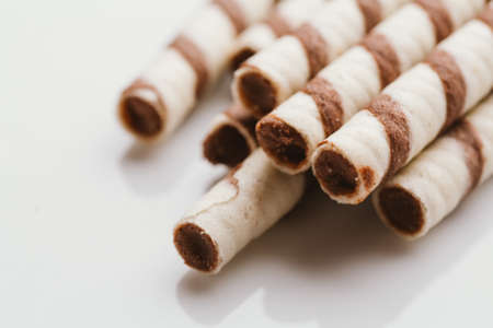 wafer rolls with nut filling on a light mirror background.の写真素材