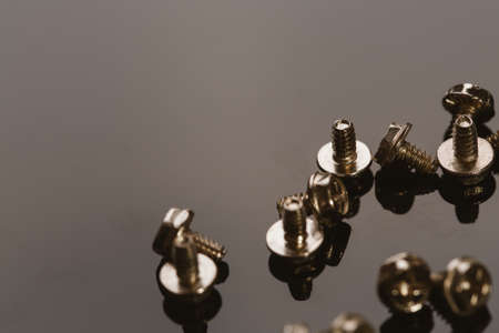 screws for a computer on a dark background.の写真素材