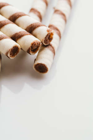 wafer rolls with nut filling on a light mirror background.の写真素材