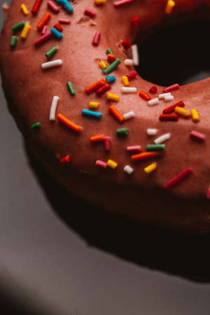 Fresh delicious donut with strawberry cream on a dark background.の写真素材