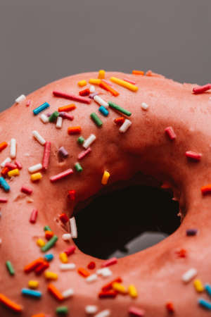 Fresh delicious donut with strawberry cream on a dark background.の写真素材
