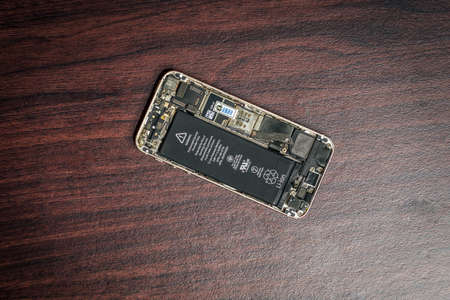 A broken and damage hand phone isolated over wooden background