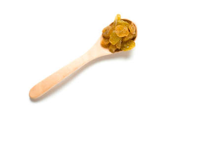 A dried raisin in a wooden spoon isolated over white backgroundの写真素材